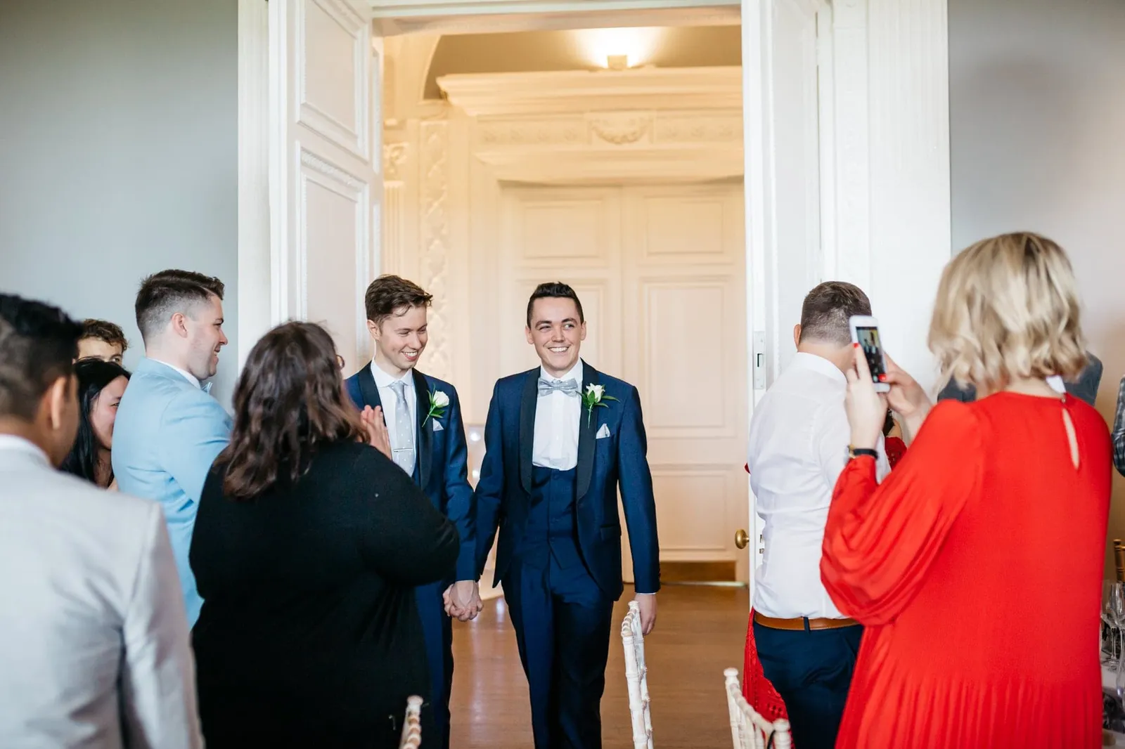 Grooms entering wedding breakfast