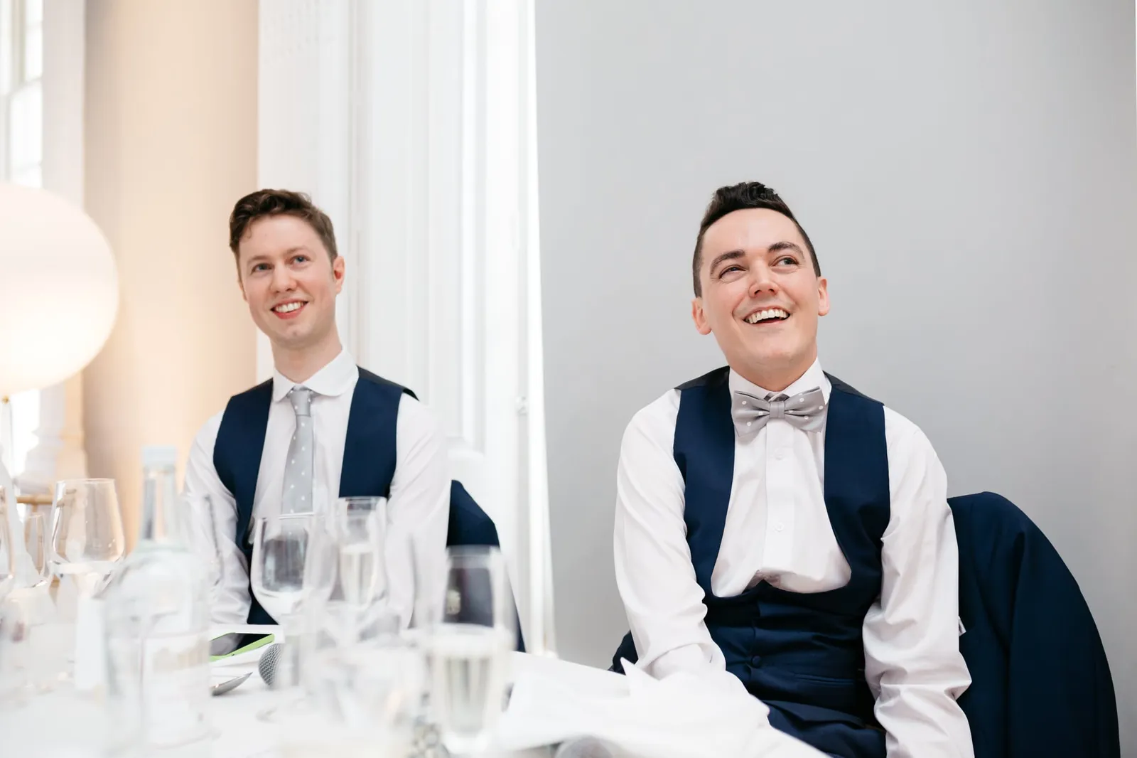Grooms laughing